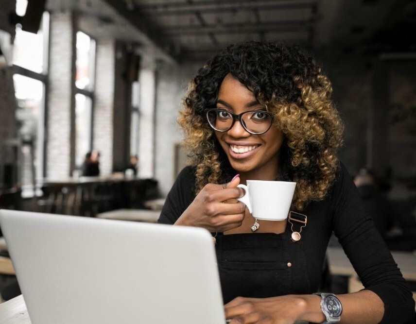 HR Compliance - A picture of an HR professional smiling amidst her busy day