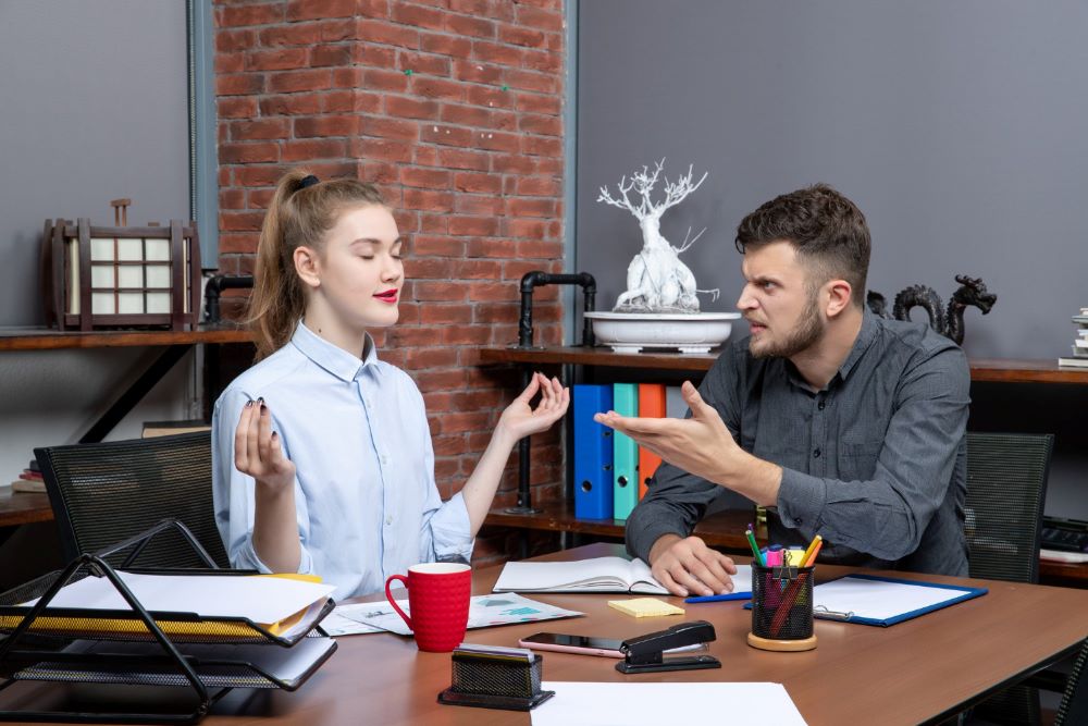 A Picture of a young man being angry with his female colleague