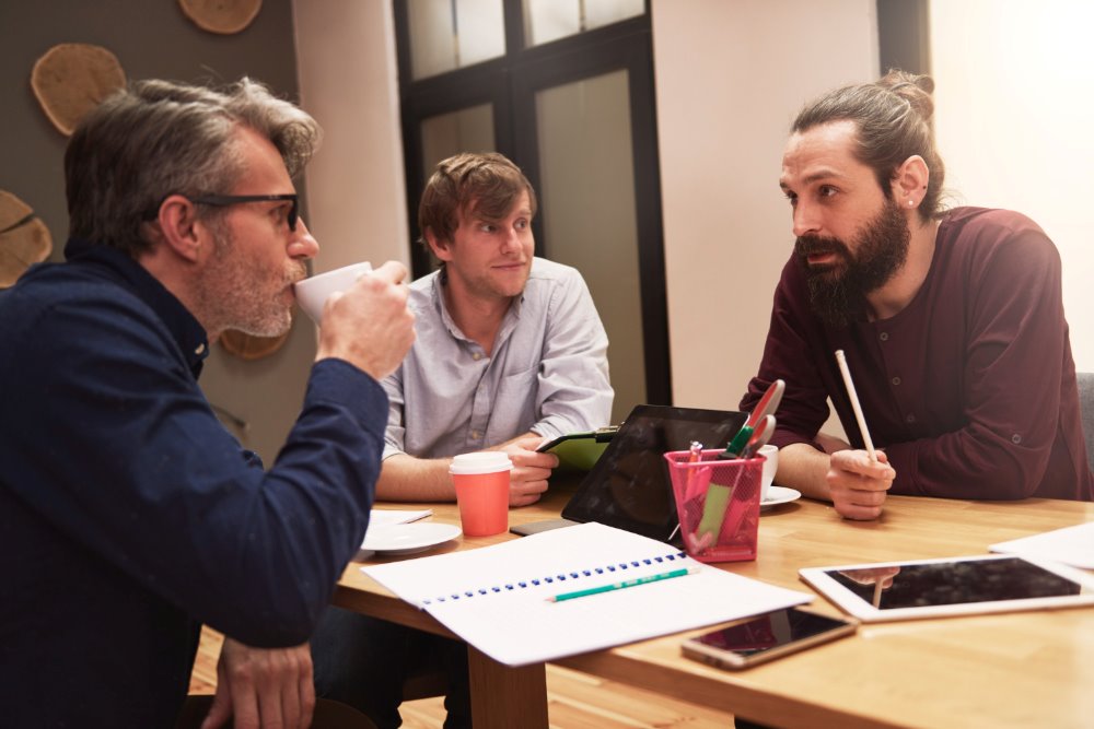 A Picture of a group of creative people analyzing work results