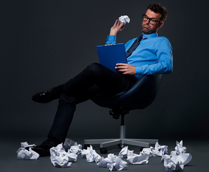 A Picture of a man crampling paper ideas